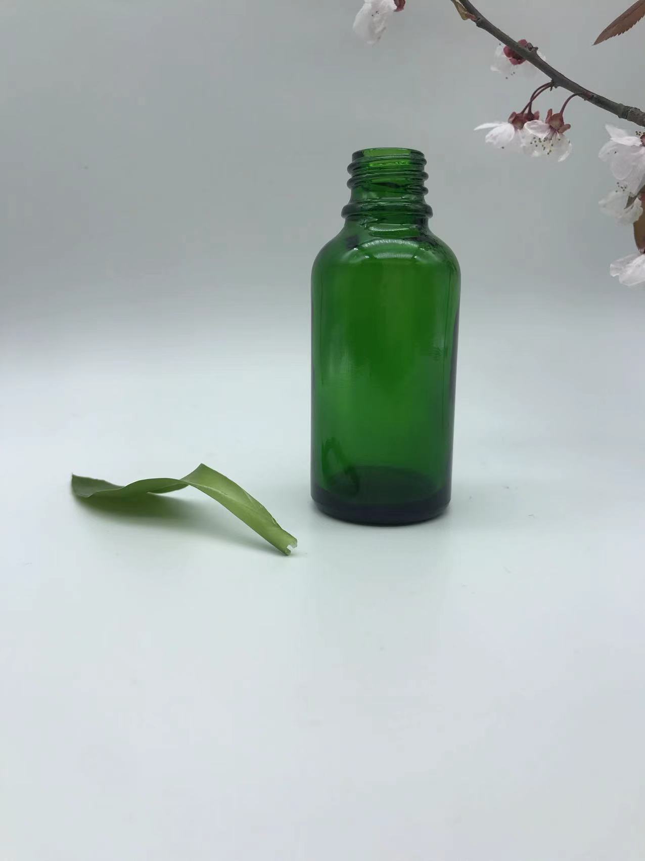 green dropper glass bottle